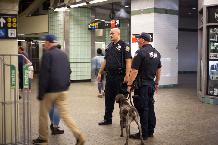 officers and dog in subway