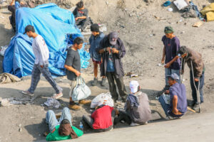 immigrants waiting to cross the border in tijuana canal, mexico