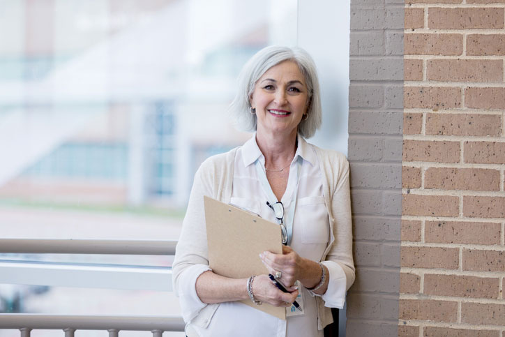 social worker leaning on wall