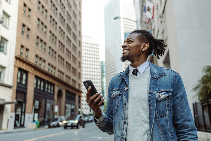 man using his phone on the streets