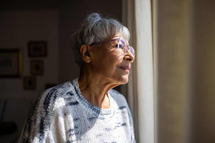 elderly woman staring out the window