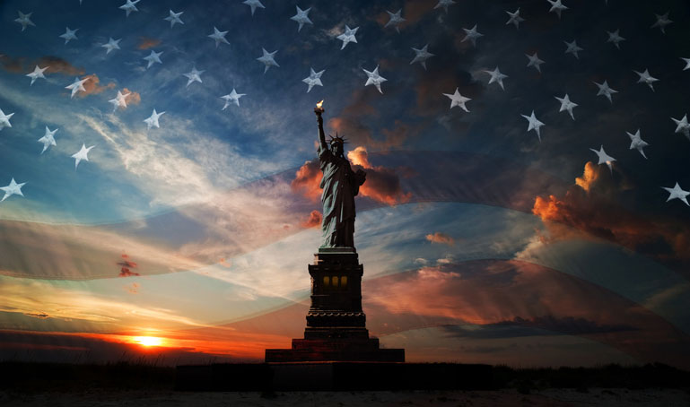 us flag over statue of liberty