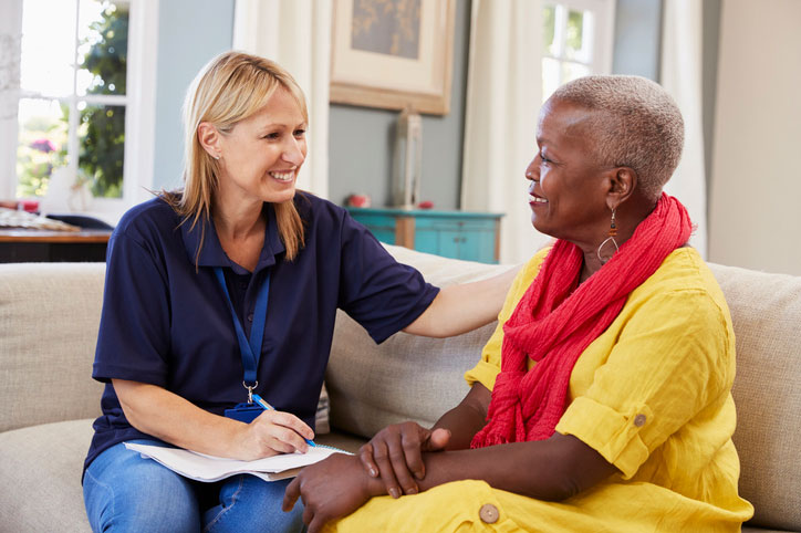 supporting hand on back of elderly woman