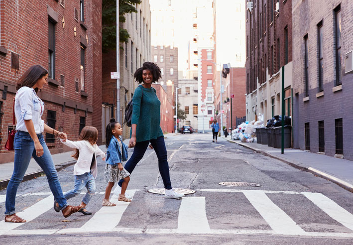 parents crossing the street with kids